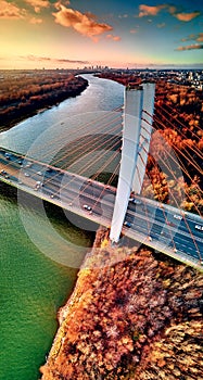 Beautiful panoramic aerial drone view to cable-stayed Siekierkowski Bridge over the Vistula river and Warsaw City skyscrapers,