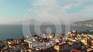 Beautiful panoramic aerial view on the center of Sorrento city, sunset, houses and streets, sea views and a Vizuvius, Napoli in th