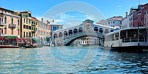 Beautiful panoramic cityscape in Venice, Italy, with picturesque old buildings surrounding the Rialto Bridge on the Grand Canal, a