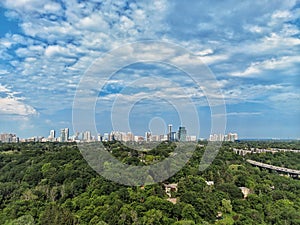 panoramic landscape aerial top view of summer day in Toronto city, North York, Canada. Blue sky with white clouds, green park.