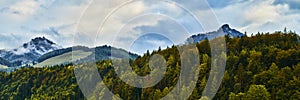 Beautiful panoramic landscape with colorful forests, Alpine mountains and dramatic sky near Wolfgangsee lake in Austria