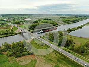 Beautiful panoramic landscape from the height of the bridge over the river. Traffic of cars on the bridge over the river