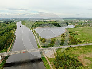 Beautiful panoramic landscape from the height of the bridge over the river. Traffic of cars on the bridge over the river