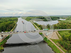 Beautiful panoramic landscape from the height of the bridge over the river. Traffic of cars on the bridge over the river