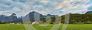 Beautiful panoramic landscape with lush green grass land and Alpine mountains near Wolfgangsee lake in Austria