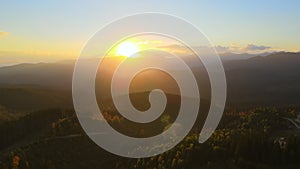 Beautiful panoramic mountain landscape with hazy peaks and foggy valley at sunset