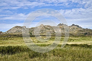Beautiful panoramic summer steppe landscape of stone mountains