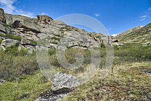 Beautiful panoramic summer steppe landscape of stone mountains