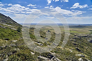 Beautiful panoramic summer steppe landscape of stone mountains