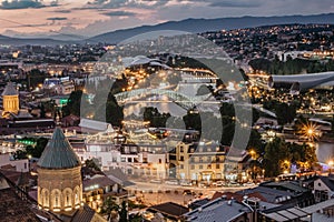 Beautiful panoramic view of evening Tbilisi, capital of Georgia. City colorful lights, river,cathedral,old buildings at a nice