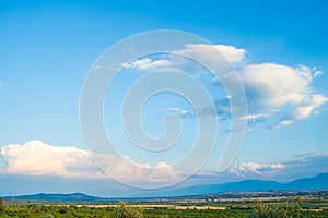 Beautiful panoramic view of green mountains and blue sky with white clouds