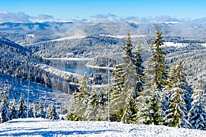 Beautiful panoramic view over the `Marisel` ski slope in winter season and Belis lake in the valley, Cluj county Romania