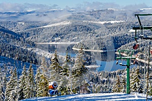 Beautiful panoramic view over the `Marisel` ski slope in winter season and Belis lake in the valley, Cluj county Romania