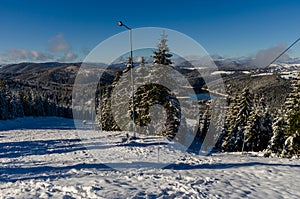 Beautiful panoramic view over the `Marisel` ski slope in winter season and Belis lake in the valley, Cluj county Romania