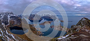 Beautiful panoramic view from Reinebringen edge on stunning mountains and village of Reine, Lofoten Islands, Norway