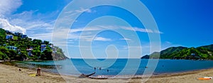 Beautiful panoramic view of Taganga, the caribbean coast with some tourists enjoying the sunny day in Colombia photo