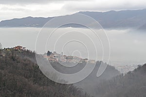 Beautiful panoramic view to heavy foggy landscape of the Calolziocorte valley near Lecco.