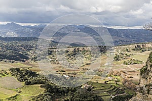 Beautiful panoramic view of the valley of Ronda with farmland and mountains in the background