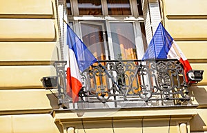 Beautiful Parisian building and French flags