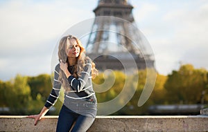 Beautiful Parisian girl near the Eiffel tower
