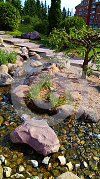 Beautiful park with the flowing stream through the stones in the residential area of the Russian city of Zelenograd.