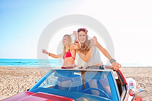 Beautiful party friend girls dancing in a car on the beach