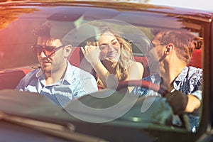 Beautiful party friend girls dancing in a car on the beach happy