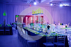 Beautiful party room set up for a wedding or social event in the ballroom orchid and lucite center piece green photo