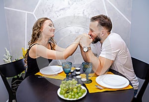Beautiful passionate couple having a romantic dinner at home