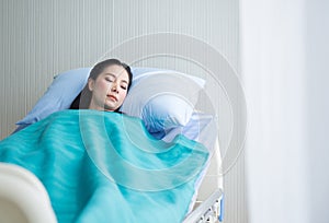 Beautiful patient asian women sleeping under blanket on sickbed at the hospital