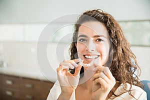 Beautiful Patient Holding Orthodontic Retainers In Dental Clinic