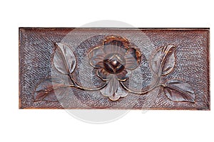 Beautiful pattern in the form of a flower and leaves on a wooden Board. Carving.