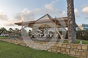 Beautiful pavilion for relaxation on the sea beach at sunset