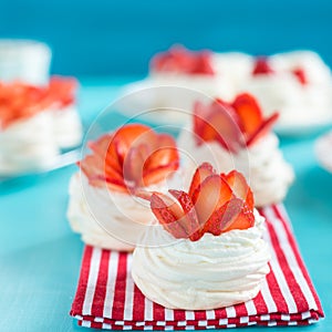 Beautiful pavlova cakes with strawberries on a blue background. Selective focus. Tasty sweet breackfast. Wedding morning. Meringue