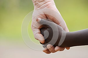 Beautiful Peace Symbol - White Woman Black Child Holding Hands. photo