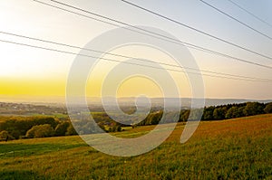 Beautiful and peaceful field with electrical transmitters during sunny day