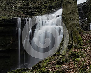 Beautiful peaceful landscape image of Scaleber Force waterfall in Yorkshire Dales in England during Winter morning