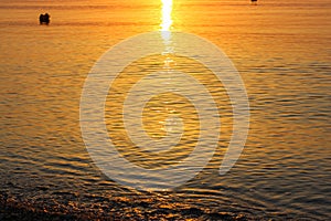 Beautiful and Peaceful Reflexion of the Sun in the Sea at Sunrise