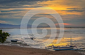 Beautiful Peaceful Sunrise with Juking boats at Sanur beach in Bali, Indonesia