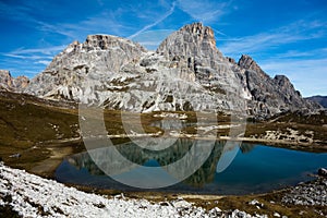 Beautiful peak reflection in alp lake in italian dolomites