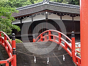 Beautiful red bridge in the garden of a Japanese Shinto shrine photo