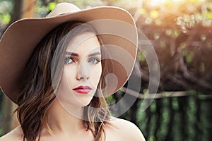 Beautiful perfect woman face outdoors. Pretty girl in hat, lifestyle portrait