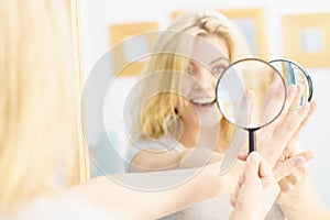 Woman using magnifer on nails