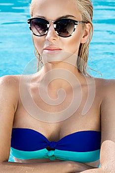 Beautiful phenomenal stunning elegant luxury blonde model woman with perfect face wearing a sunglasses stands with elegant sw