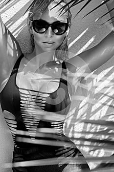 Beautiful phenomenal stunning elegant blonde model woman with perfect face wearing a sunglasses stands with elegant erotic sw