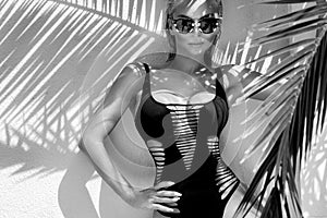 Beautiful phenomenal stunning elegant blonde model woman with perfect face wearing a sunglasses stands with elegant erotic sw