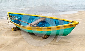 Beautiful photo of beached Fishing Canoe, the canoe is painted colorful in traditional asian manner. It is idle in off season