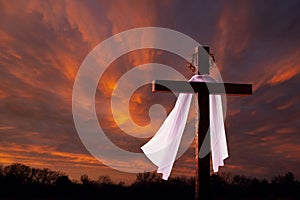 Beautiful photo illustration of brilliantly colorful Easter morning sunrise with a large wooden cross, burial cloth and crown of t