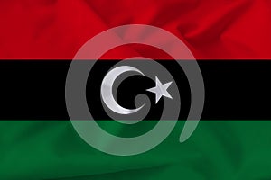 Beautiful photo of the national flag of Libya on delicate shiny silk with soft draperies, the concept of state power, country life