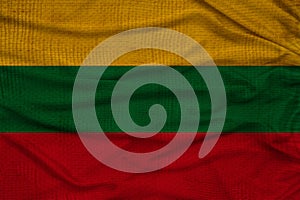 Beautiful photo of the national flag of Lithuania on delicate shiny silk with soft draperies, the concept of state power, country